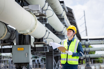 Engineer working at high voltage power substation infrastructure inspection check with safety...