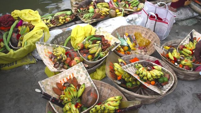 traditional Chhath Puja dalas (offering baskets) placed on the sacred Ganga Ghat. deep devotion, Indian spirituality, and age-old Vedic rituals performed by devotees to honor Sun God Chhathi Maiya. 