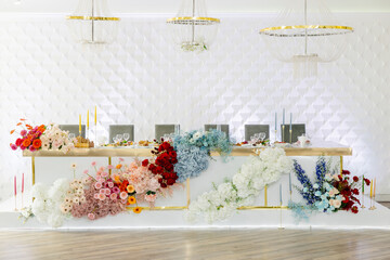 Wedding table decorated with colorful flowers and candles