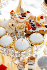 Delicious macarons and pastries decorating a luxurious candy bar buffet