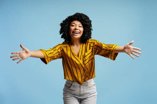 Enthusiastic young woman opening arms for a hug