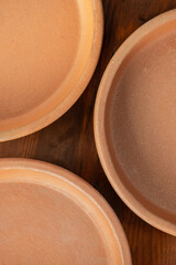 Georgian ketsi top view. Ketsi, traditional handmade unglazed ceramic cookware, clay round frying pan, dish, plate, pot, all in one, close-up, high resolution.