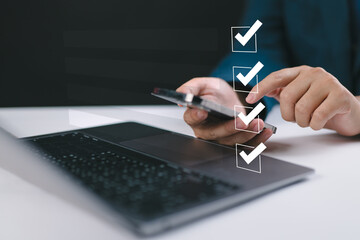 Digital smart checklist and business management concept. Businessman uses laptop to mark paperless...