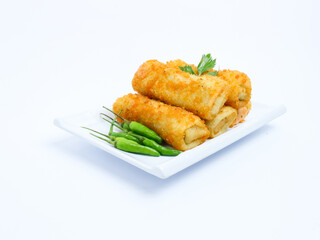 A plate of crispy golden vegetable risol served with green chili peppers and parsley garnish. isolated on white background. risol isolated