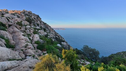 A Serene Rocky Landscape Overlooking the Vast Ocean at Sunset Time, Majestic and Calm