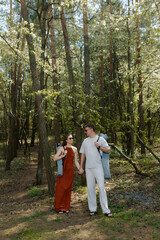 Fototapeta premium Couple enjoying a leisurely stroll in a serene forest during sunny spring afternoon