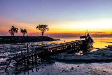 The natural background of the morning light by the sea, the local fishing pier in Ban Tha Sala, Nakhon Si Thammarat, has the beauty of the golden light of the sun.