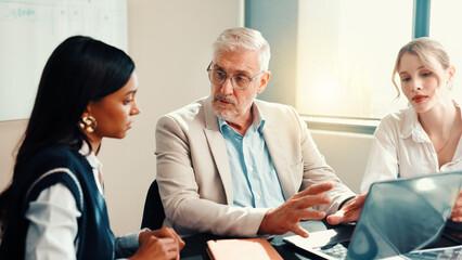 Talking, mentor or business people on laptop with feedback for teamwork, collaboration and...