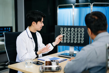 Friendly doctor discussing brain scan results with patient on screen. Health consultation,...