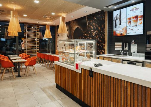 06.01.2025, Ustron, Poland. Modern McDonald's fast food restaurant interior with self-service kiosks and seating area, casual dining atmosphere, clean and contemporary design