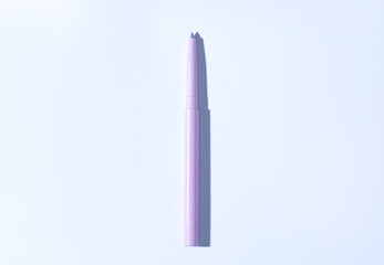 One twist up eye pencil on white background, top view