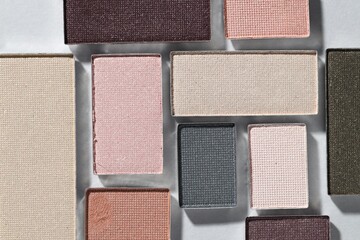 Fototapeta premium Beautiful eyeshadow refill pans on light background, flat lay