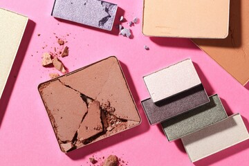 Beautiful eyeshadow refill pans on pink background, flat lay
