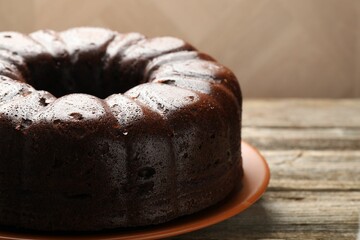 Tasty chocolate bundt cake on wooden table, closeup