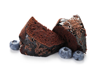 Pieces of delicious chocolate bundt cake and blueberries isolated on white