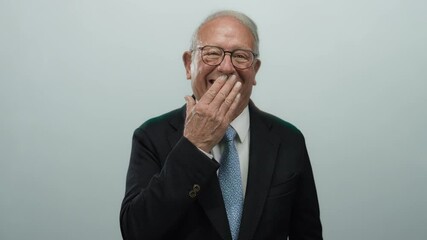 Senior businessman in a suit covering his mouth with one hand, isolated on white background, expressing surprise, emotion and contemplation in a corporate setting. - Powered by Adobe
