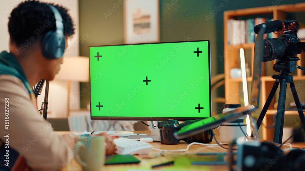 Poster Green screen, computer and man with live streaming in home for editing project on videography. Technology, content creation and back of male influencer with recording for online podcast in apartment.