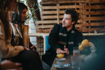 A casual gathering of friends enjoying time together indoors in a warm, rustic atmosphere.