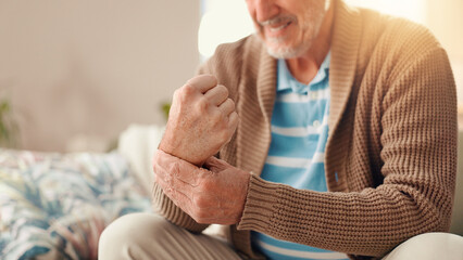 Senior man, hands and injury with muscle tension for carpal tunnel syndrome or fibromyalgia at home. Elderly, male person or sore wrist with pain, discomfort or ache for arthritis or chronic illness