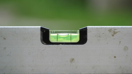 Using a level tool to ensure precision in construction and renovation tasks outdoors