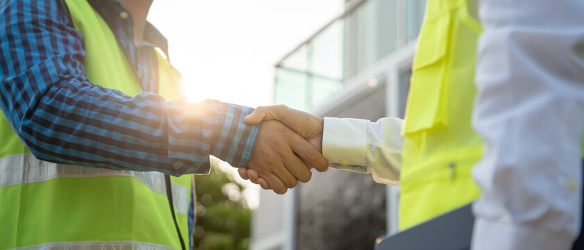 Construction team hands shaking greeting start up plan new project contract in office center at construction site, industry ,architecture, partner, teamwork, agreement, property, contacts..