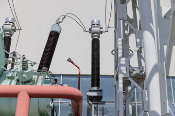 Close-up of high-voltage insulators and electrical components at an outdoor power substation