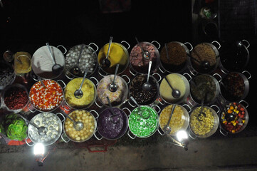 Various colorful Vietnamese Che  for sale in Night Market in Hue, Vietnam. Chè is any traditional Vietnamese sweet beverage, dessert soup or pudding.