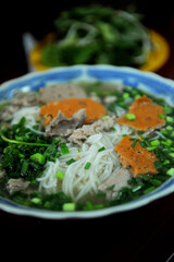 A bowl of Bún bò Huế (Spicy Beef & Pork Noodle Soup). It originates from Huế, a city in central Vietnam associated with the cooking style of the former royal court.