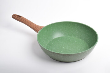 Green frying pan with a non-stick coating isolated on white background