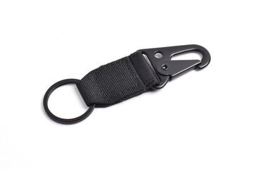 Black tactical keychain with carabiner hook and nylon strap isolated on white background.