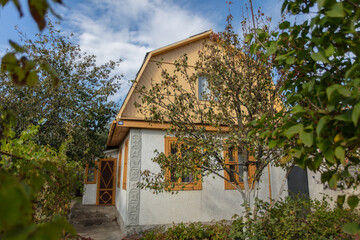 A small brick country house on a summer street.