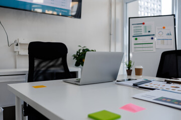 the atmosphere of an office in a company, a desk full of office supplies, a conference room with clear glass that lets in sunlight, the atmosphere of a modern conference room