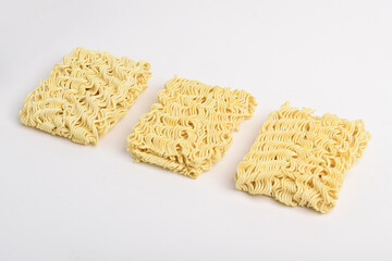 Three Raw instant noodles isolated on white background