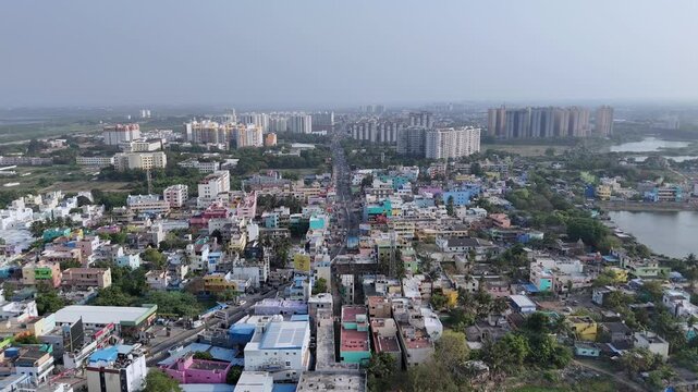 An aerial view of a city in Tamil Nadu, India. residential and taller modern buildings, road networks with vehicles, and some green undeveloped areas. Coimbatore skyscrapercity