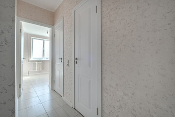 long empty corridor in interior of entrance hall without furniture of modern apartments, office or...