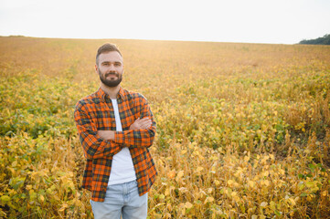 Farmer, agronomist in the soybean field. Controlling the growth of agricultural crops