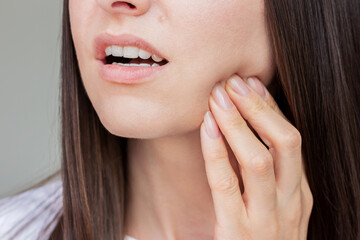 Young pretty caucasian woman suffering from gingivitis, gum inflammation, toothache. Dental care....