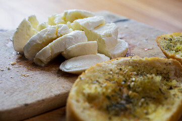 Mozzarella and garlic Bread on wooden plate for mediterranean breakfast