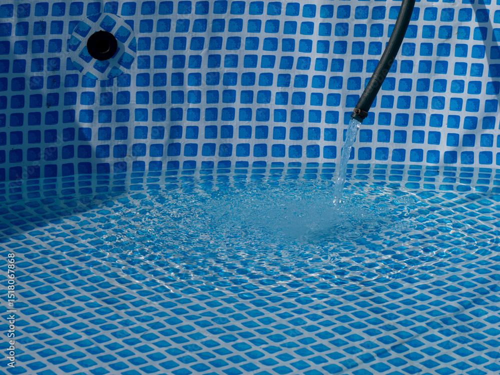 Poster A pool with a blue tile floor and a hose running into it