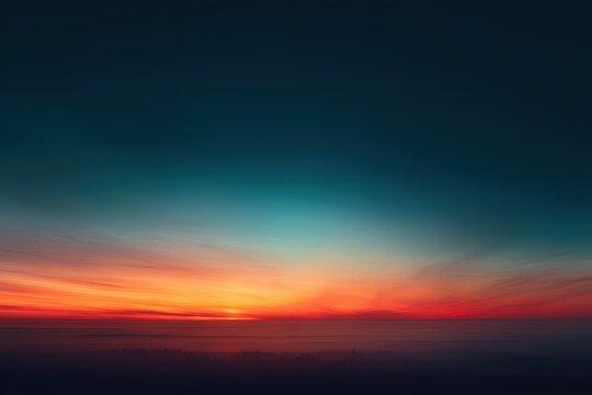 Vibrant sunset hues paint a low-hanging, hazy sky, transitioning from deep teal to fiery orange and red, with a subtle glow on the horizon