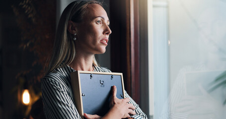 Woman, picture and sad by window with memory, mourning and regret or loss of loved one at home....