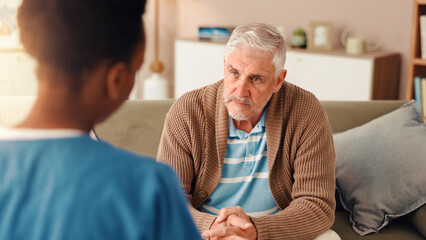 Nurse, advice and healthcare with old man on sofa for occupational therapy, listening and consulting. Medical, caregiver and retirement with senior person in nursing home for wellness and support