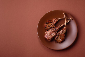Juicy meat on the bone or rack of lamb. Grilled veal with salt, spices and herbs