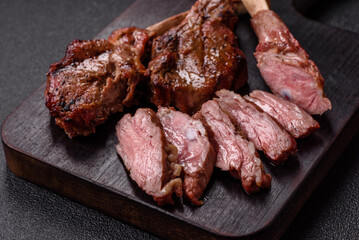 Juicy meat on the bone or rack of lamb. Grilled veal with salt, spices and herbs