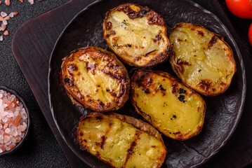 Food, potatoes cut in halves or slices grilled. Cooked baked potatoes