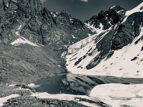 A panoramic view of a moraine Lake number 6 (Manshuk Mametova) in Almaty, Kazakhstan nested among rugged snow-capped mountains