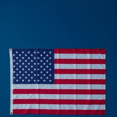 Top view of American flag on dark blue studio background with copy space