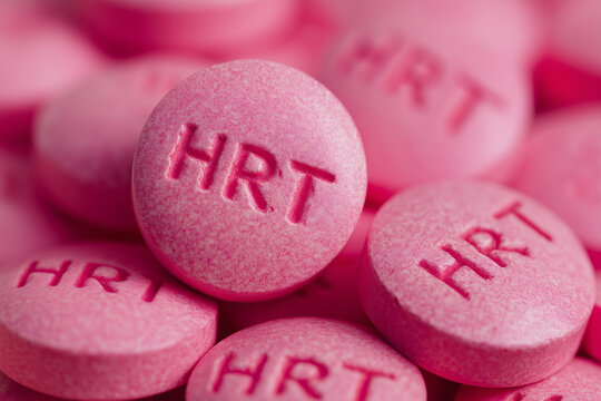 pile of pink HRT pills close up, hormone replacement therapy for menopause symptoms