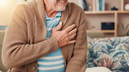 Senior man, hands and sofa with chest pain for medical emergency or cardiac arrest at home....
