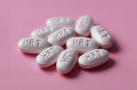 pile of white HRT pills close up, hormone replacement therapy for menopause symptoms
